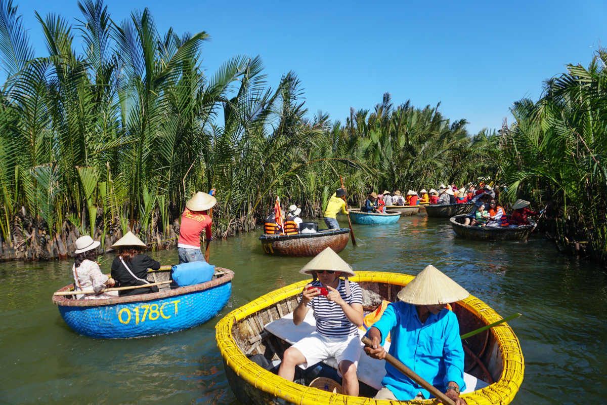 Visitors in basket boats paddling through coconut groves in Hoi An Coconut Village