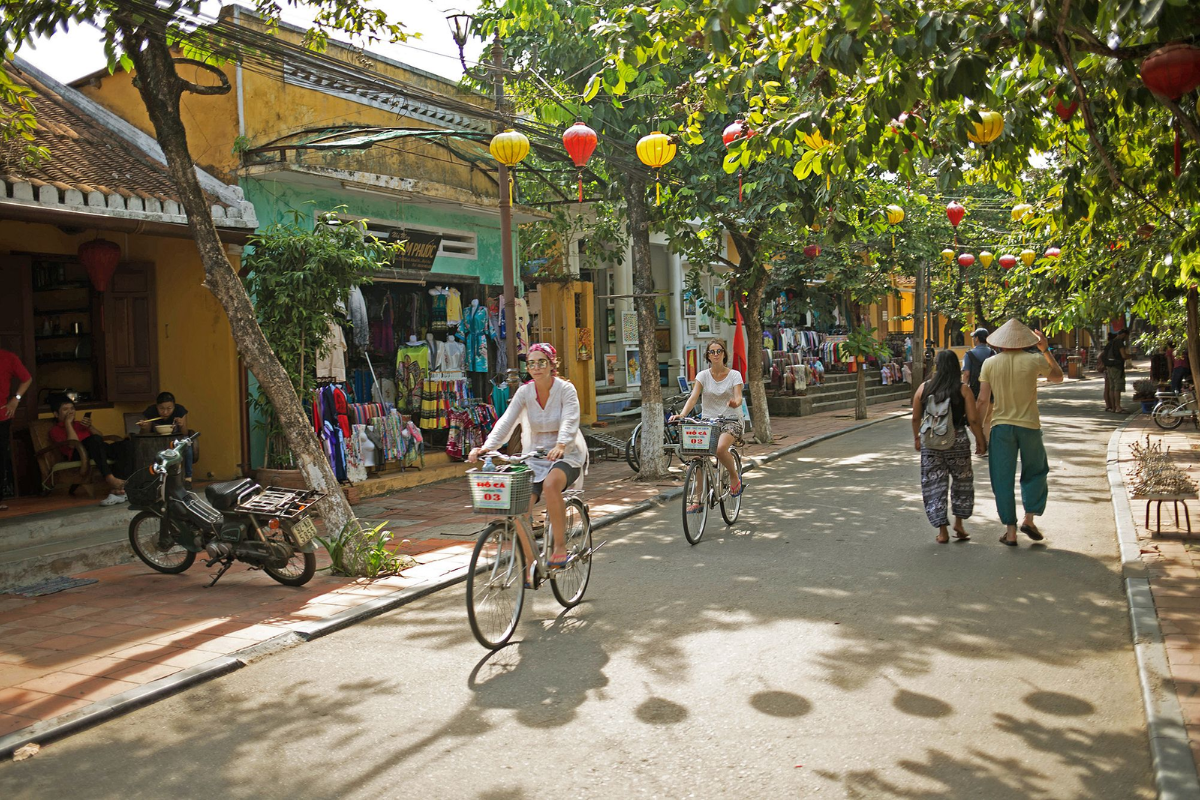 Tourists cycling around Hoi An Ancient Town in July
