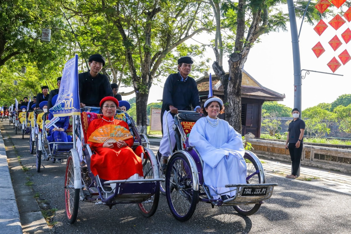 Tourist enjoying a cyclo ride through the streets near Hue's Imperial Citadel.