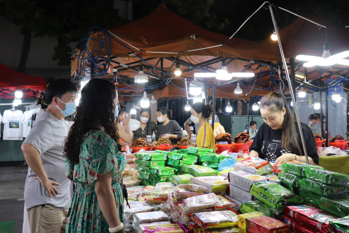 Vibrant Da Nang night market with people shopping and eating