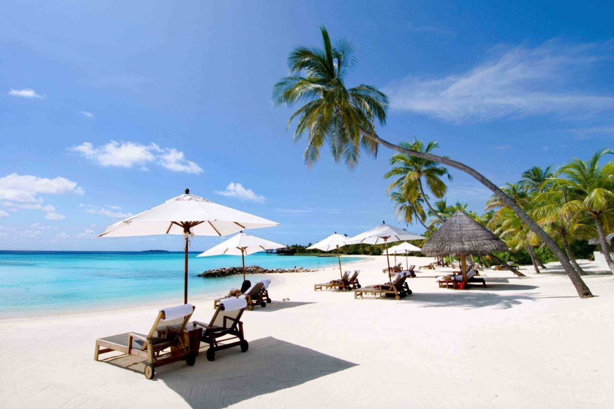 Serene view of Doc Let Beach with clear blue water and white sand in June