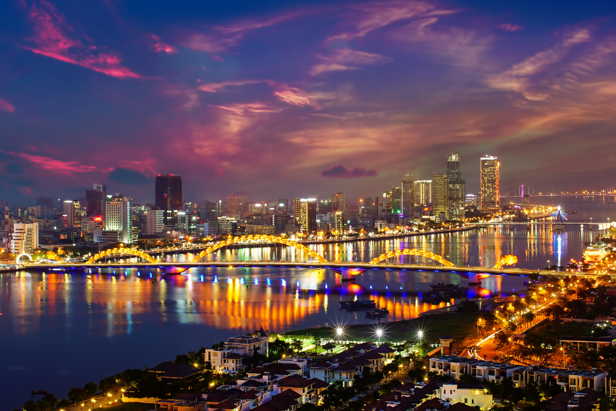 Dragon Bridge in Da Nang illuminated at night with vibrant lights