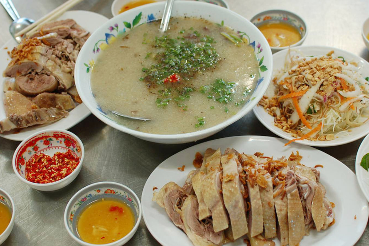 A bowl of duck porridge with fresh herbs