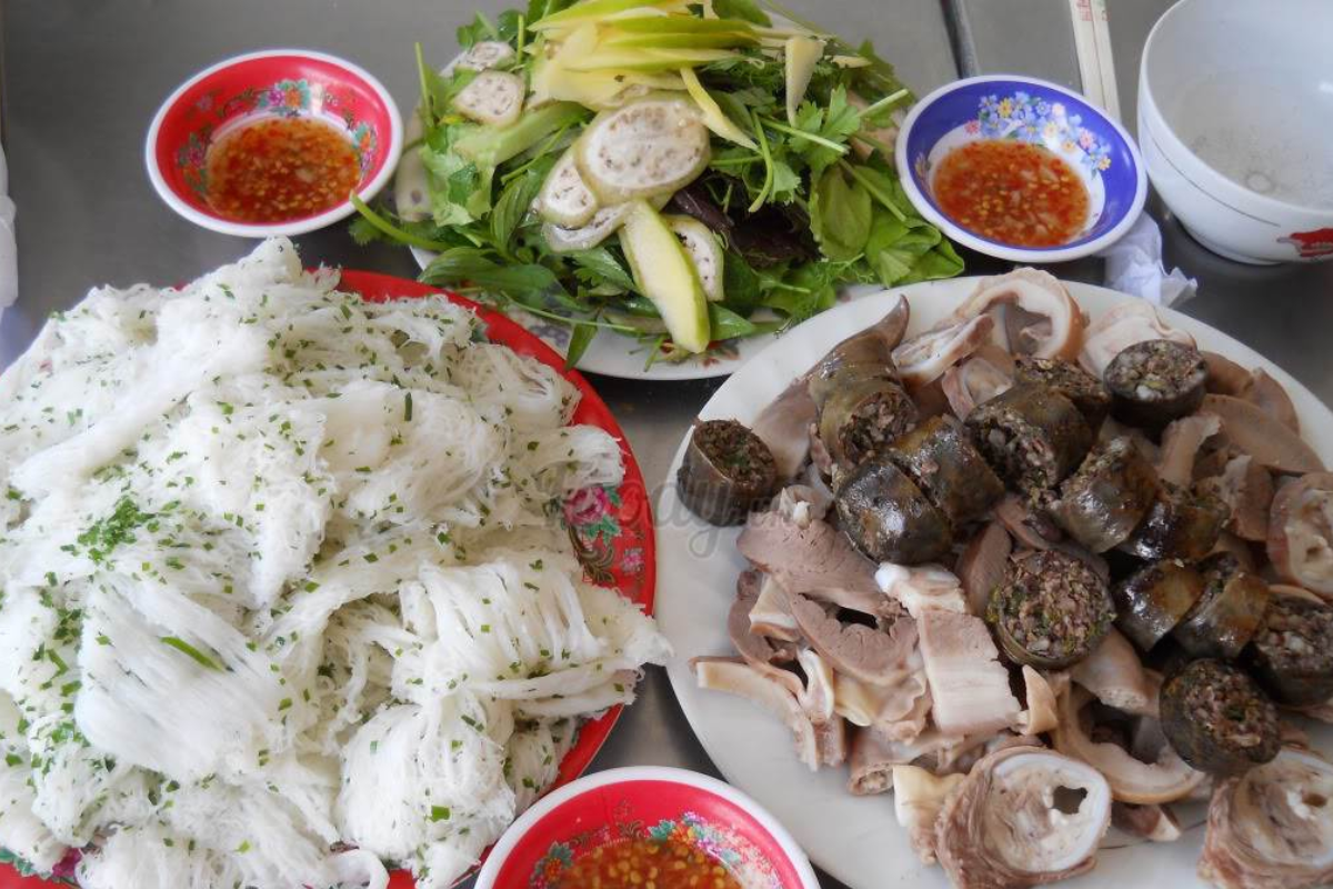 Plate of Bánh Hỏi with grilled pork, herbs, and dipping sauce