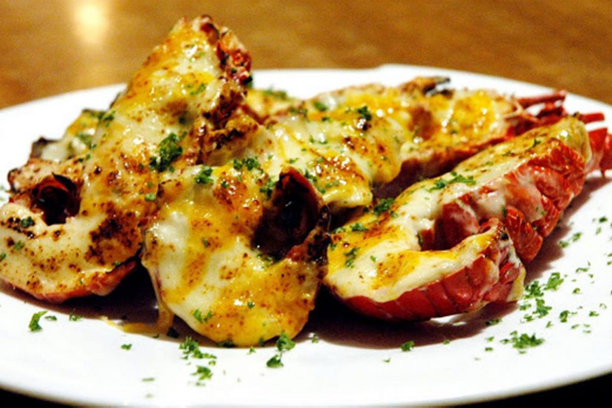 Grilled slipper lobster topped with garlic butter on a seafood platter