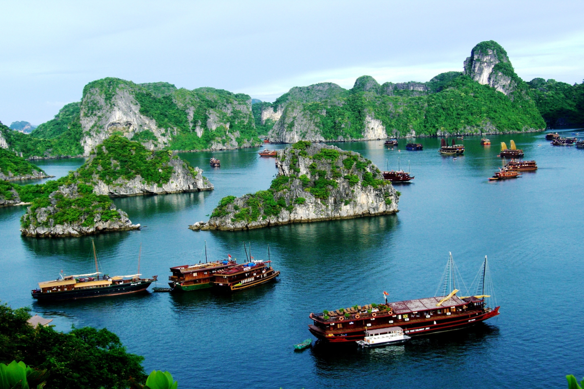 Sunny view of Ha Long Bay in June with blue skies and emerald waters