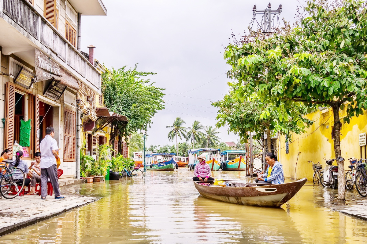 Lantern-lit boat on the Hoai River in Hoi An during November rain