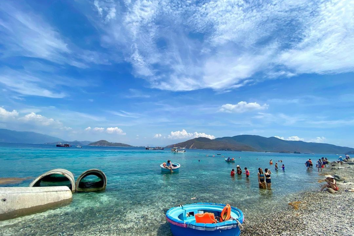 Scenic view of Hon Mun Island with lush cliffs and deep blue waters in July