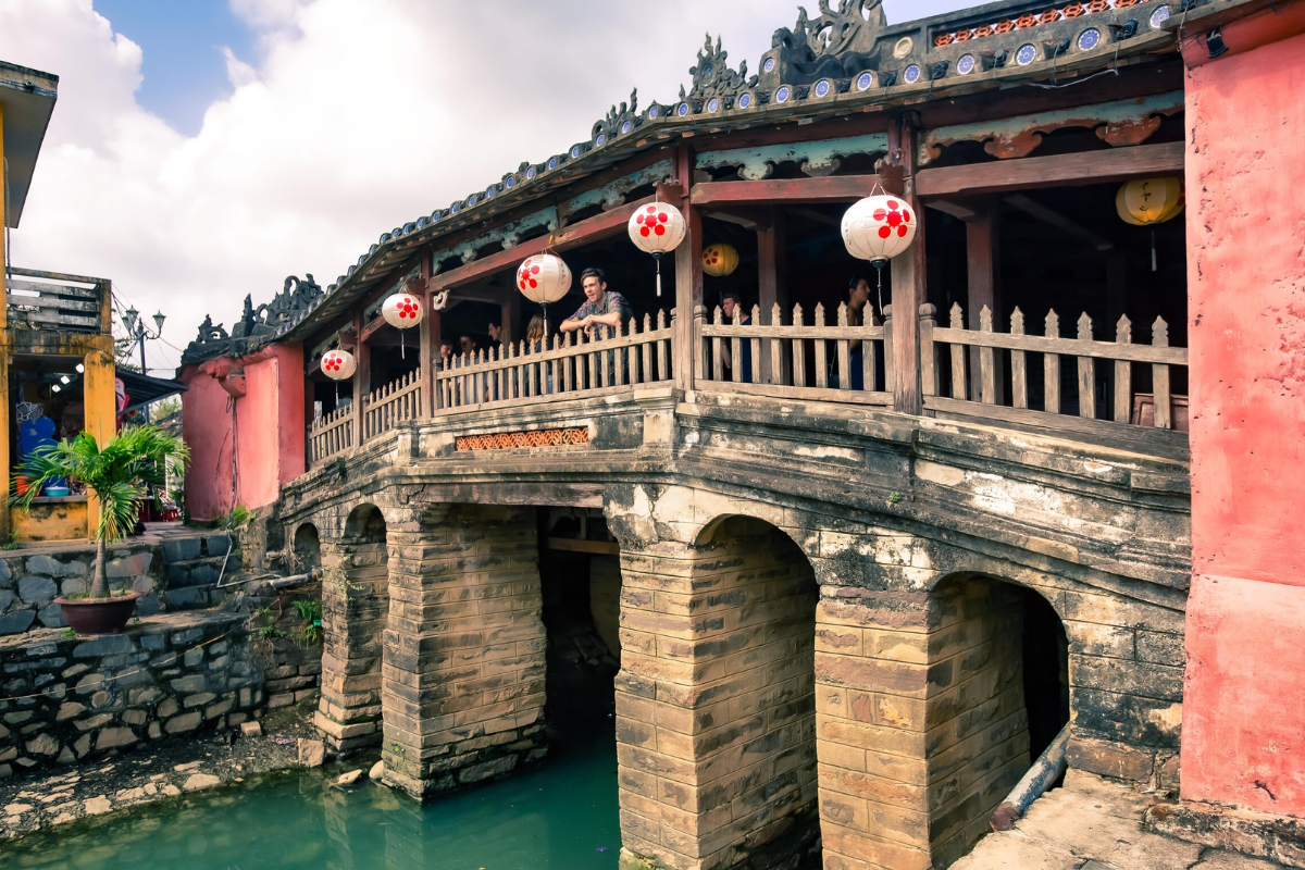 Tourists at the Japanese Bridge in Hoi An on a cloudy December day