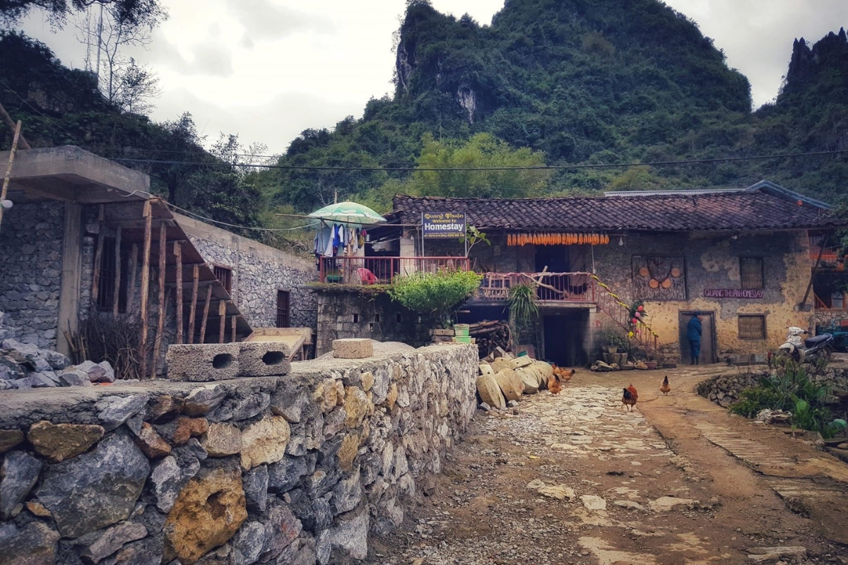 Overview of Khuoi Ky stone village with stone stilt houses and mountain backdrop
