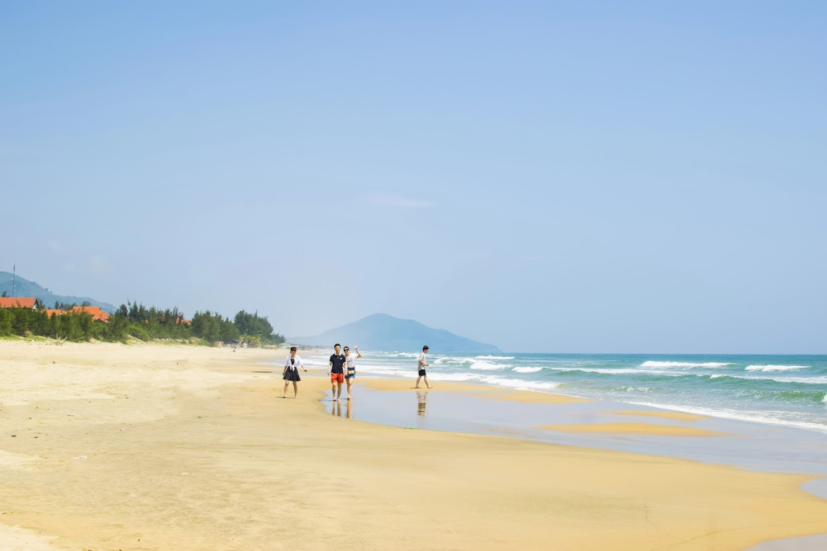 Visitors sunbathing and swimming at Lang Co Beach