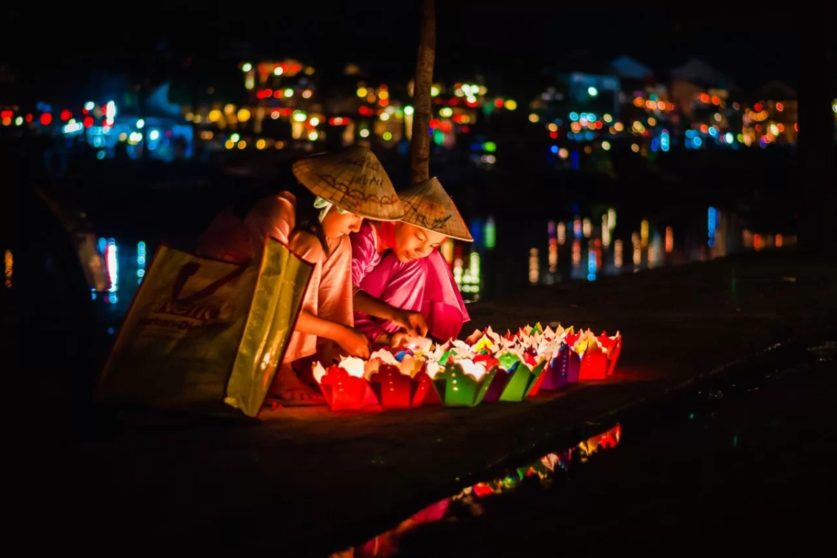 Lanterns illuminating Hoi An Ancient Town at night by the river