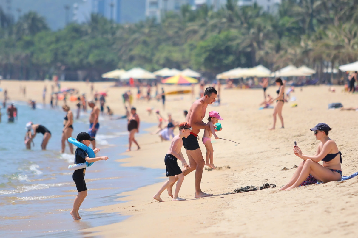 Tourist enjoying clear blue skies on Nha Trang beach in April