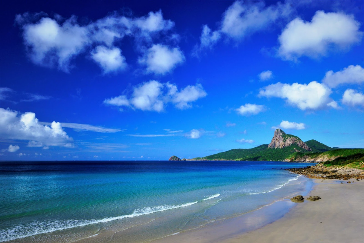 Rocky coastline and crystal waters at Nhat Beach, Con Dao