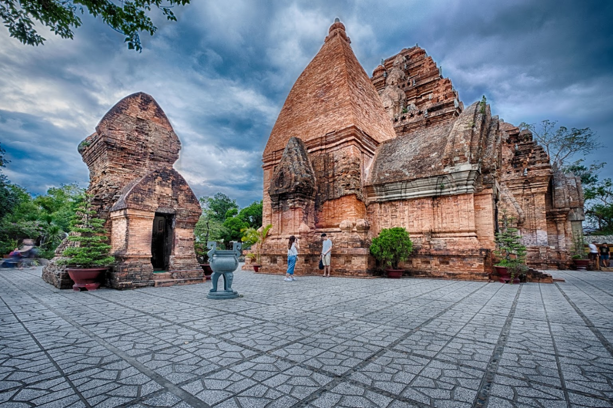 Ancient Ponagar Cham Towers under the sun, surrounded by greenery and blue skies
