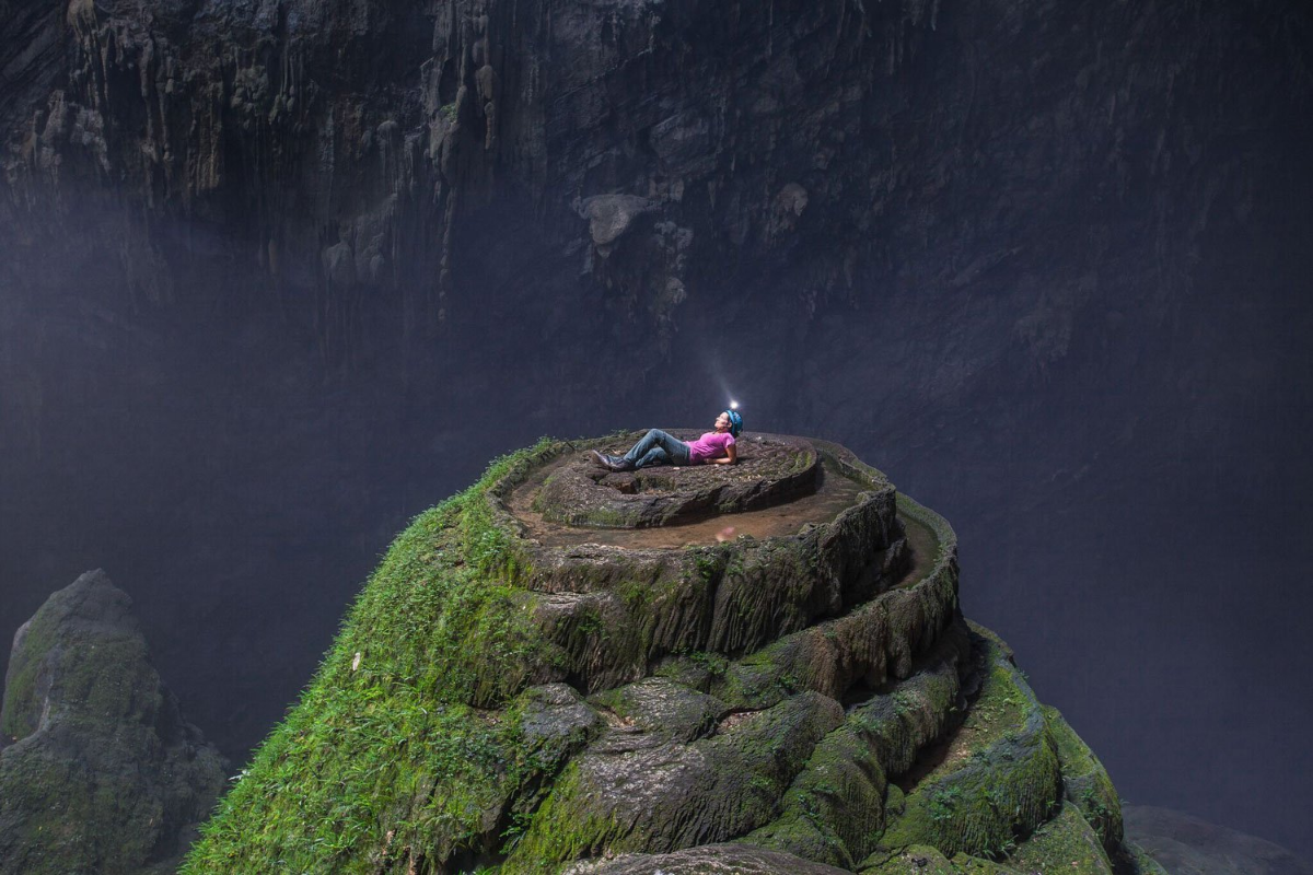 The immense cavern of Son Doong Cave, lit naturally through a collapsed ceiling