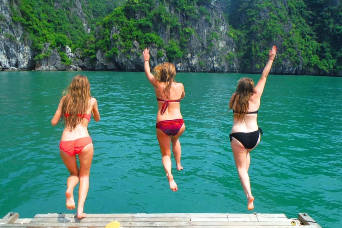 Tourists swimming in the warm sea of Halong Bay in May