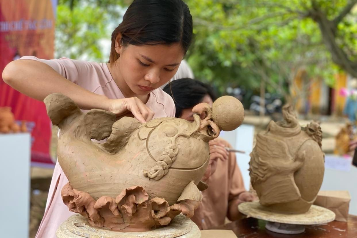 Artisan shaping pottery at Thanh Ha Pottery Village in Hoi An