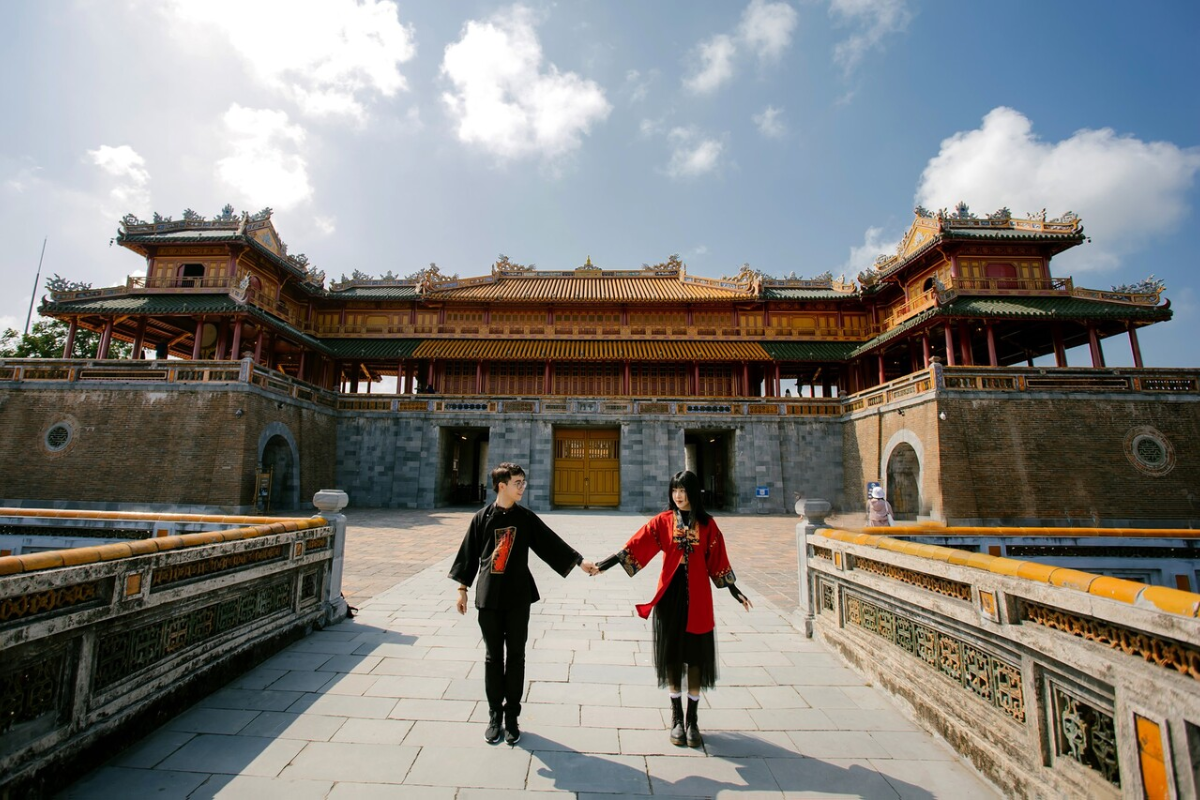 The Imperial City of Hue on a clear March day with tourists walking through ancient gates