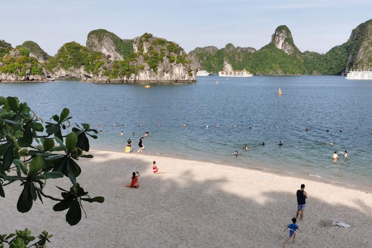 Tourists enjoying the beach and viewpoint on Ti Top Island in Ha Long Bay