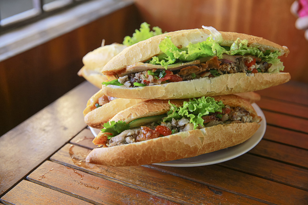 A Vietnamese Banh Mi filled with meat, vegetables, and pate
