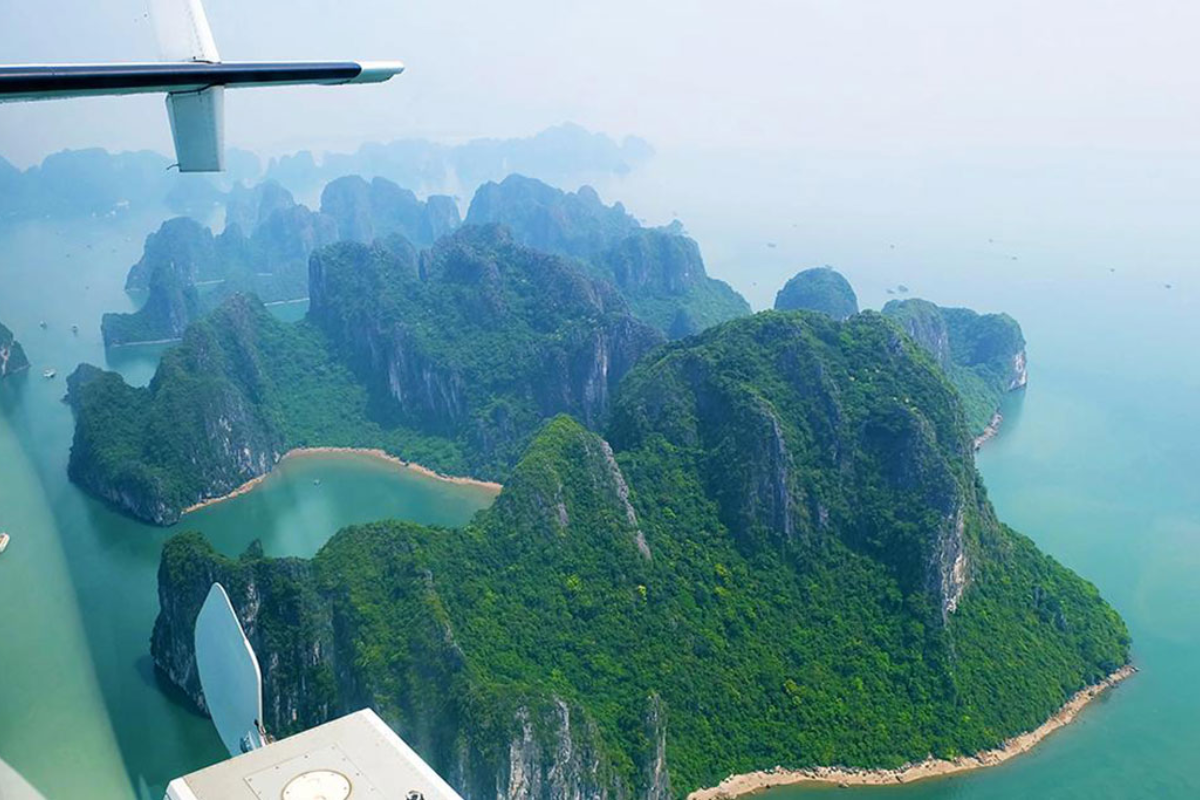 Aerial view of Ha Long Bay’s islets and emerald waters from a seaplane