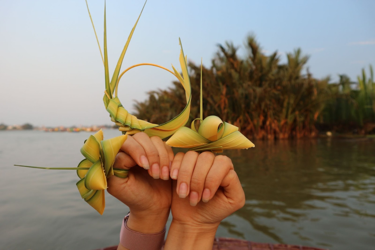 Visitors making coconut leaf crafts in Hoi An Coconut Village workshops