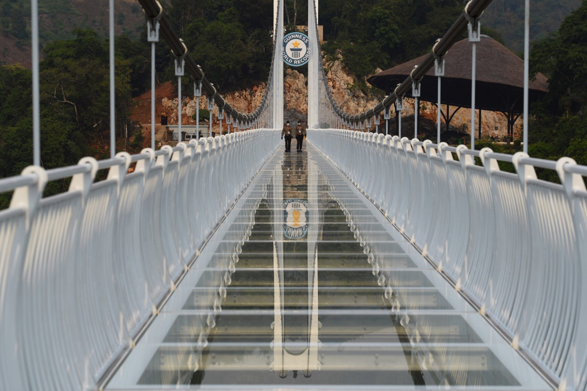 Bach Long Glass Bridge spanning the forested valley in Moc Chau