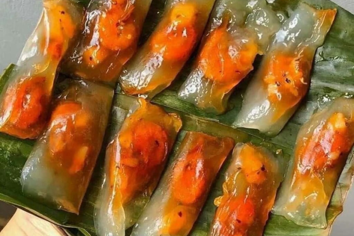 Plates of Banh Beo and Banh Bot Loc served with fresh herbs and fish sauce