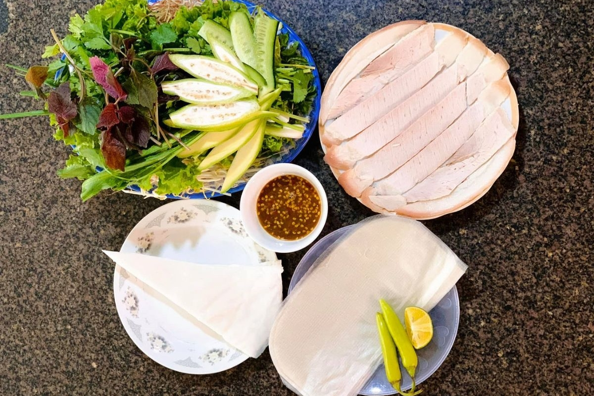 Sliced pork with rice paper and fresh herbs