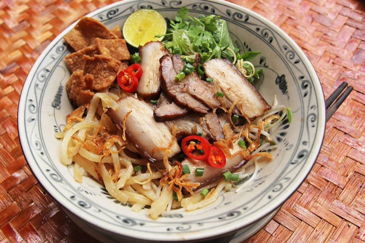 Cao Lau - A bowl of thick noodles with pork and fresh greens