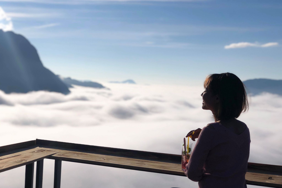 A cozy coffee shop with a view of the misty mountains in Sapa