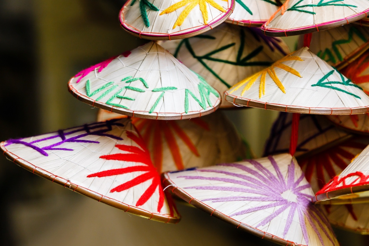 Collection of traditional Vietnamese souvenirs like conical hats, coffee, and lanterns.