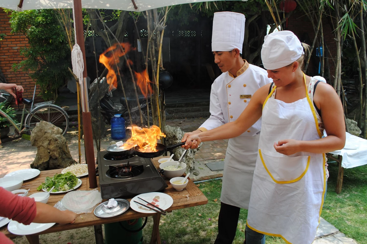 Tourists participating in a Vietnamese cooking class in Hue