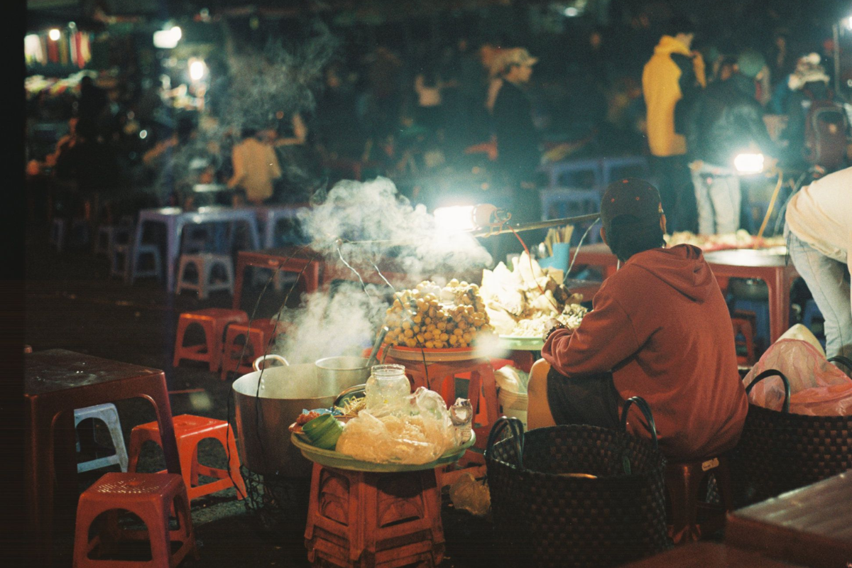 Vibrant night market in Dalat with street food stalls and local handicrafts near Xuan Huong Lake