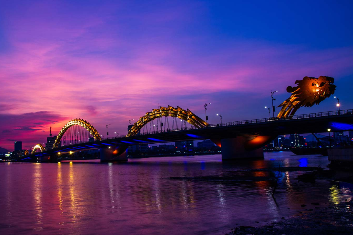 Dragon Bridge at night, illuminated with vibrant lights