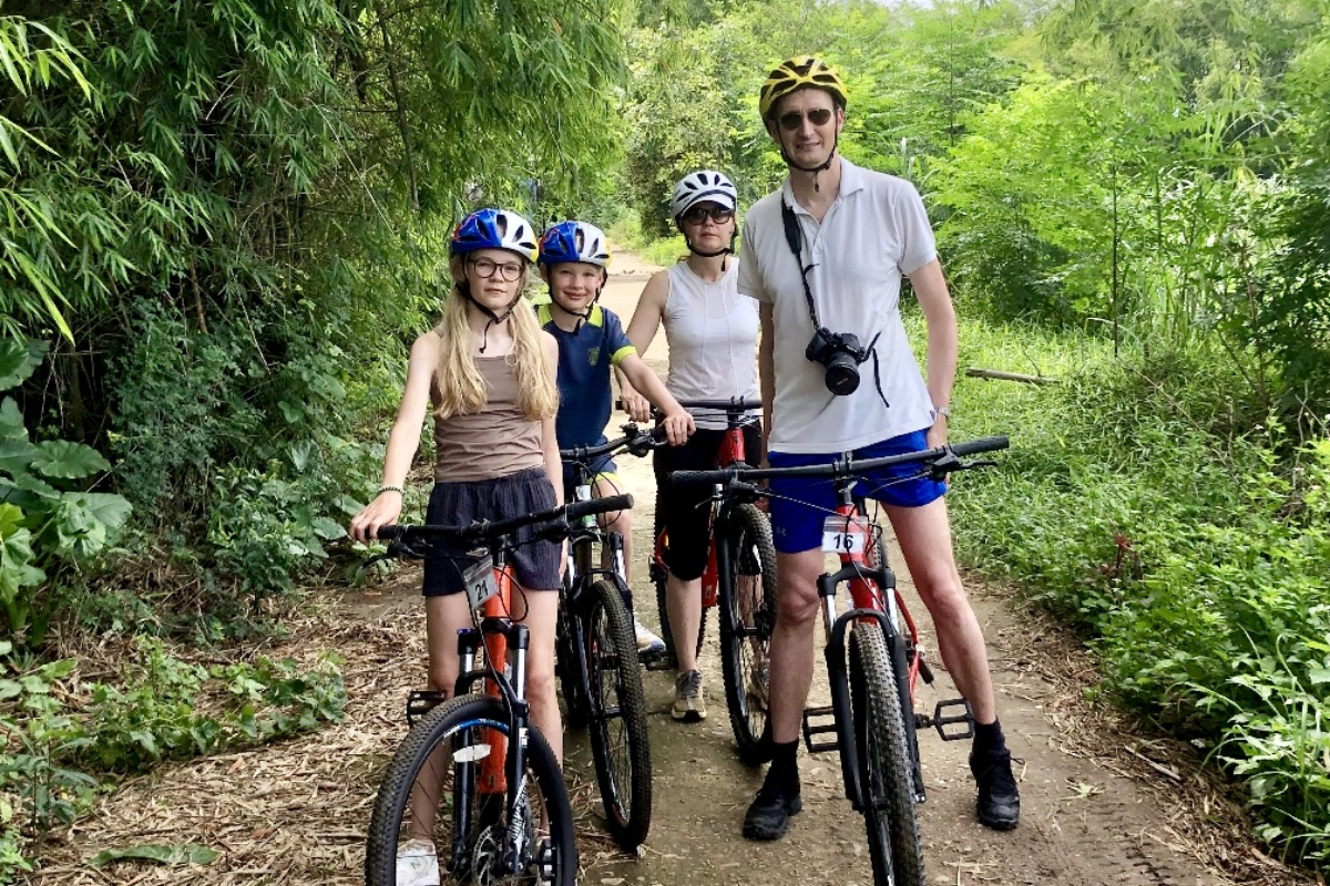 Family cycling through lush forest