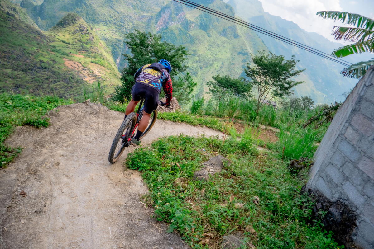 Cyclist riding through misty mountains in Sapa