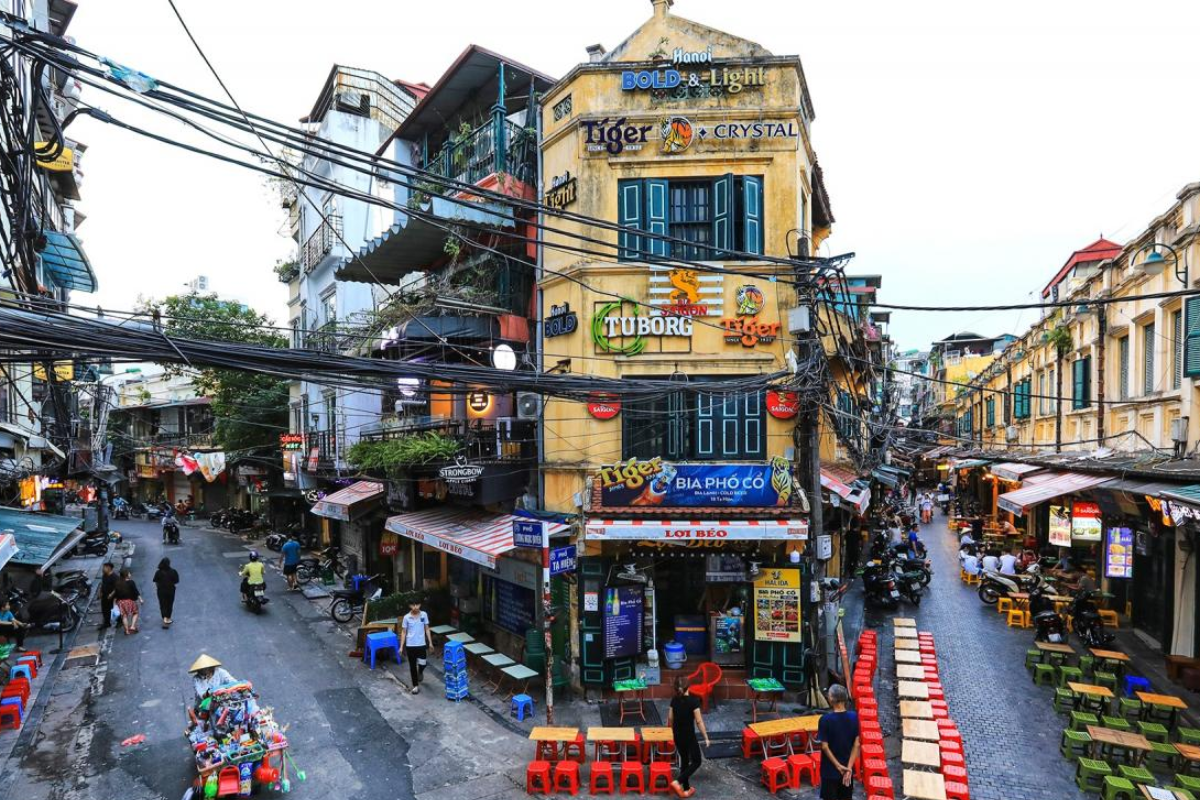 Bustling streets of Hanoi's Old Quarter with local shops and scooters