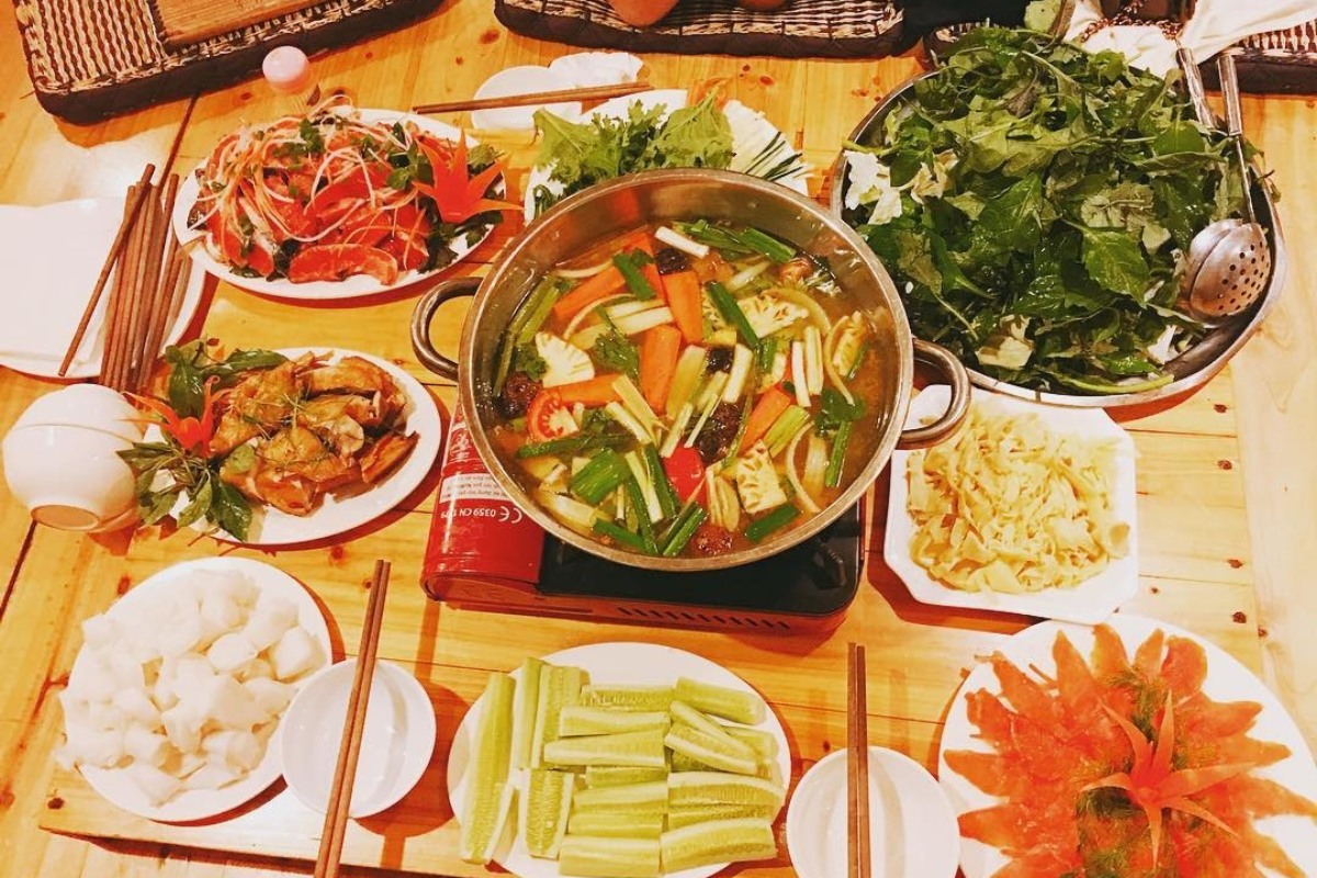 Sapa salmon hotpot with bamboo shoots, vegetables, and fresh salmon fillets