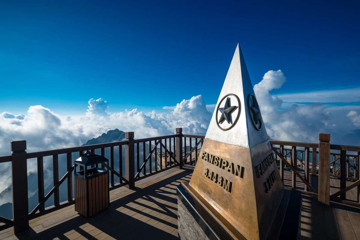 View from the top of Fansipan Mountain in April with clouds rolling over the peaks