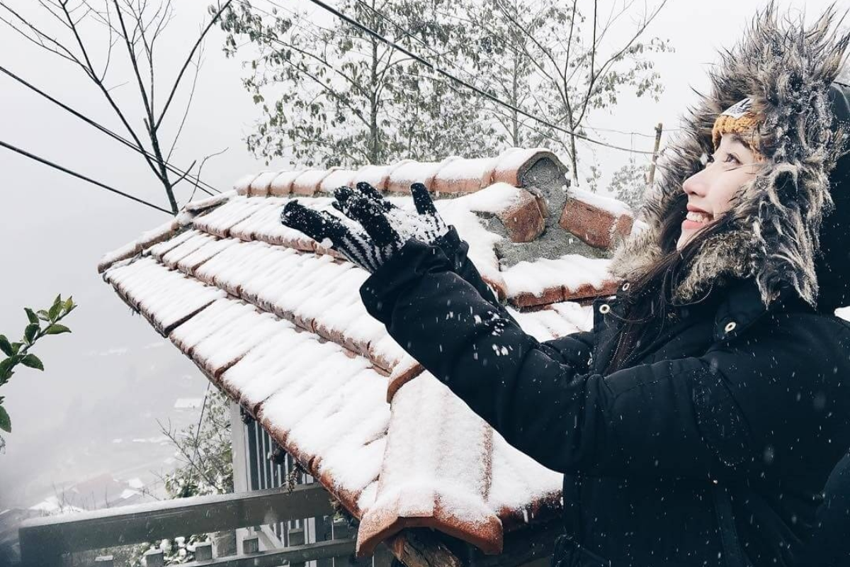 Tourists enjoying snowfall in Sapa Vietnam