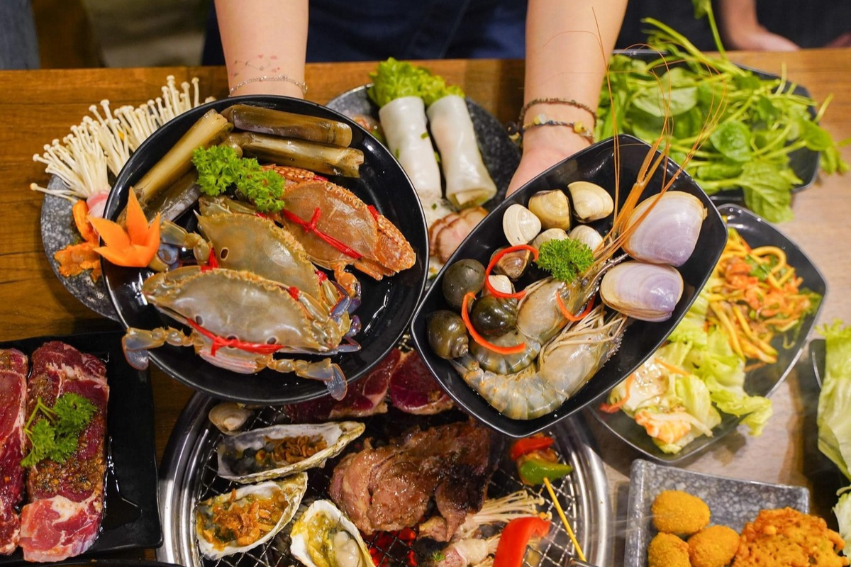 A plate of fresh seafood including grilled prawns and fish