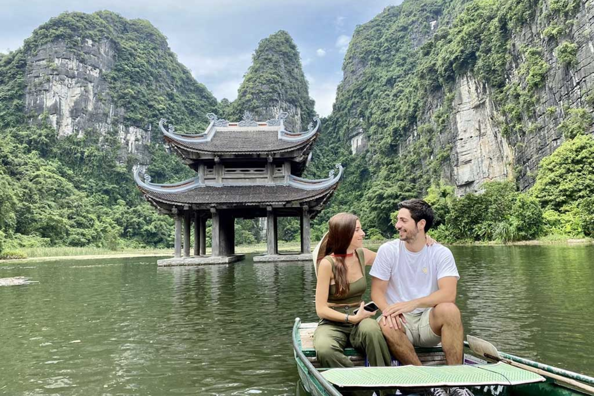 A couple enjoy boat trip in Trang An, Ninh Binh