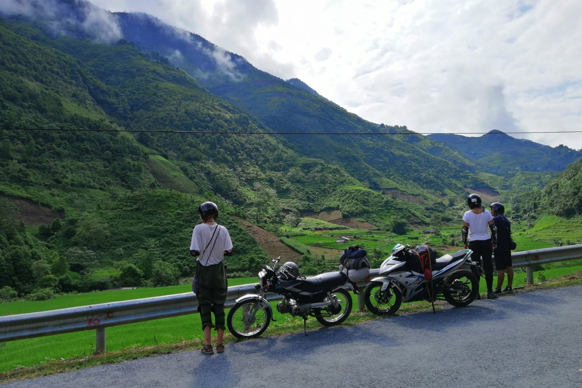 Traveler on a motorbike exploring Ha Giang's winding roads