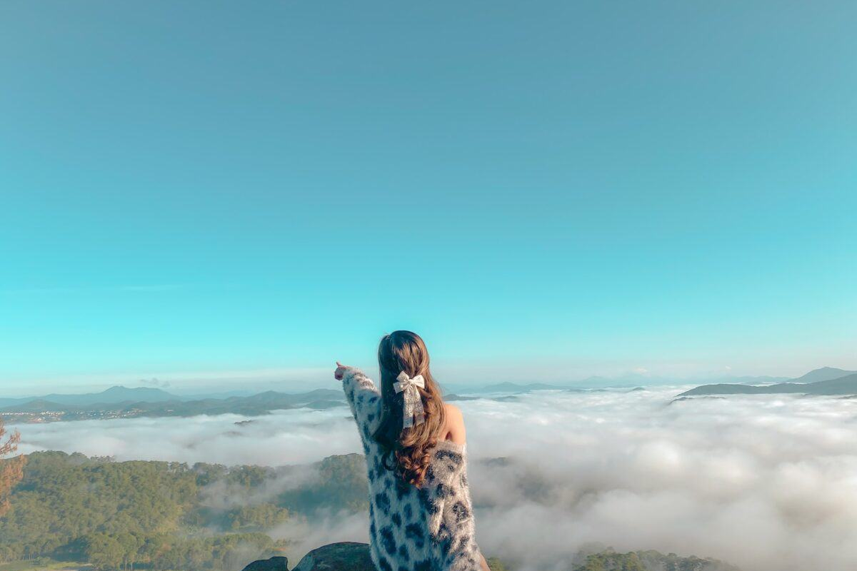 A Visitor at a Da Lat viewpoint watching morning clouds roll over the hills